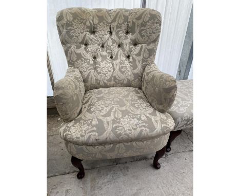 A BUTTON-BACK 'JADE' FIRESIDE CHAIR ON FRONT CABRIOLE LEGS 