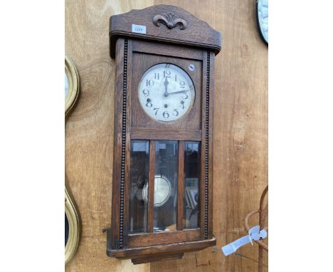 A MID 20TH CENTURY OAK CASED EIGHT DAY WALL CLOCK 
