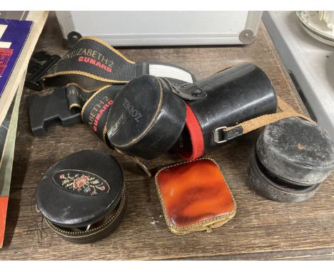 TWO 'ZODEL' LENS IN LEATHER CASES, AN ENAMELLED COMPACT, CASED SEWING KIT AND A 'QEII' CUNARD LUGGAGE STRAP 