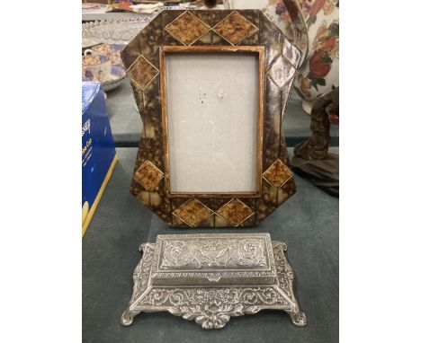 AN ORNATE PHOTO FRAME AND A SILVER PLATED STAMP HOLDER 