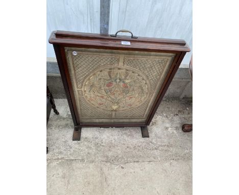 A VICTORIAN FIRESCREEN WITH PULL-UP PANEL DECORATED WOOLWORK DEPICTING FLOWERS, 25" WIDE 