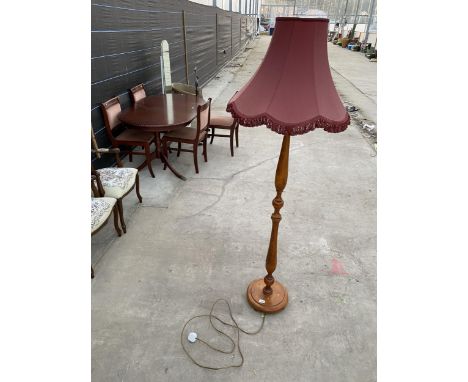 A BEECH STANDARD LAMP COMPLETE WITH BURGUNDY SHADE 