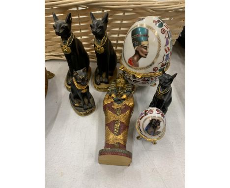 FOUR MODELS OF EGYPTIAN CATS, 'KING TUTS' SARCOPHAGUS PLUS TWO CERAMIC EGGS WITH EGYPTIAN DECORATION 