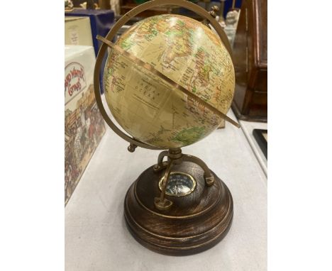 A WORLD GLOBE WITH A COMPASS ON A WOODEN BASE HEIGHT APPROX 24CM 