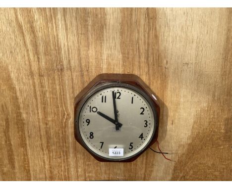 A VINTAGE WOODEN CASED OCTAGONAL CLOCK BEARING THE STAMP 'GviR PALACE THEATRE MANCHESTER' 