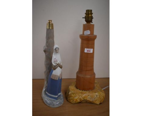 A lladro, or Lladro style lamp base and a turned wood lamp base.