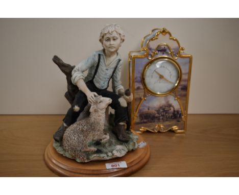 A cast Capo-di-Monte style shepherd figure, depicting a young boy sat on a tree stump, marked BA, on a moulded wooden base 25