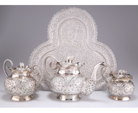 AN INDIAN SILVER THREE-PIECE TEA SERVICE AND TRAY, PROBABLY KASHMIR, CIRCA 1900, chased with foliage, each with elephant-form