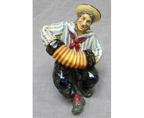A Royal Doulton ceramic figure, 'Jolly Sailor,' HN2172, of a sailor playing a concertina. 16.5cm high.