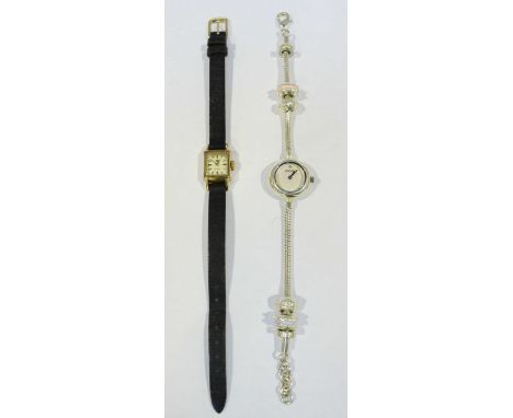 A gold plated ladies Omega cocktail wristwatch, the rectangular case with silvered dial and batons denoting hours, on black l