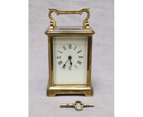 A French brass carriage clock with white enamel dial and Roman Numerals, platform escapement and "Patent French Make" stamped