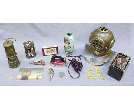 An assortment of mixed collectables including a brass divers helmet, a musical Davy lamp, a small clothes iron, a cloisonné p