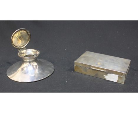 An early 20th century silver capstan inkwell, with loaded base, 14cm diam, together with a cedar-lined silver oblong cigarett