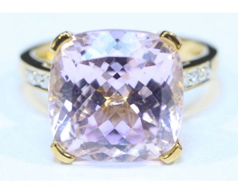 An 18ct gold Kunzite and diamond ring, set with a large central, cushion cut Kunzite (approx weight 11.25ct) and four small d