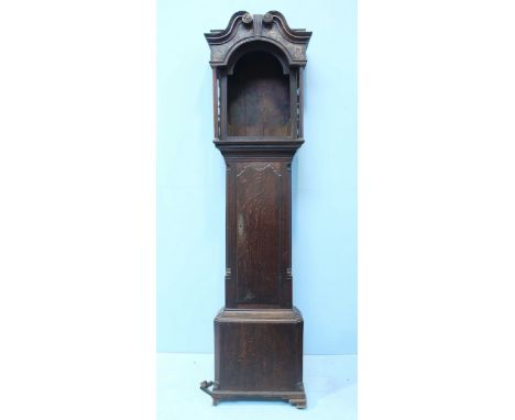 A late Georgian oak long case clock carcass, the hood decorated with swan neck pediment, the plain trunk with single hinged d