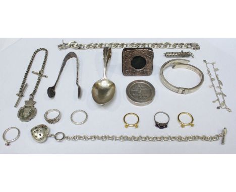 An assortment of mixed silver and white metal items including six various rings, a bangle, a spoon, a small picture frame, a 