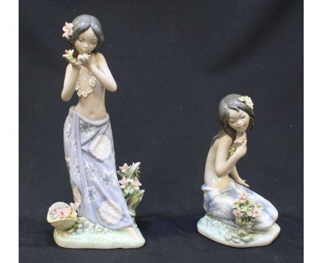 Two Lladro ceramic figures of Hawaiian girls, 'Aroma of the Islands' and 'Aloha.' The tallest figure measures 23cm high.