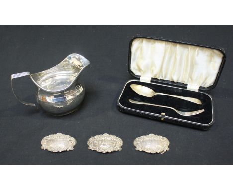 A George III Silver cream jug, hallmarked London 1809 by John Merry, AF, together with three Silver decanter labels and a box