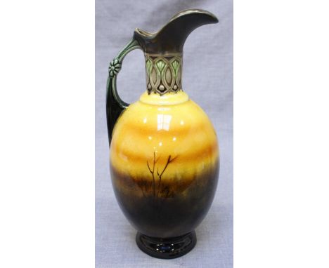 A hand painted Doulton Burslem Holbein ware style ceramic Ewer with scenic decoration of a silhouetted village scene and fiel
