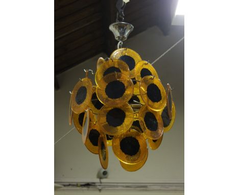 A 1960's hanging light the shade comprising black and orange disc pendants.