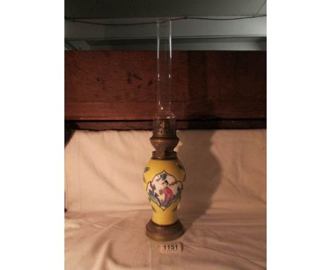 An oriental style ceramic oil lamp with chimney