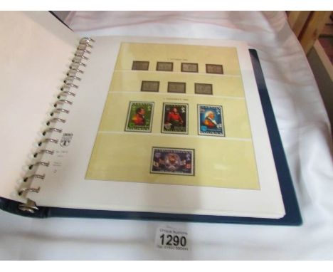 A Guernsey mint stamp collection in printed album (face value approximately £90)