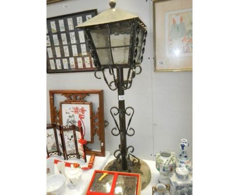 A metal garden lantern on stand