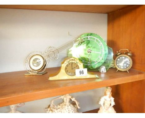 A Deco electric clock, a 1960's guitar clock, an alarm clock and a mantel clock