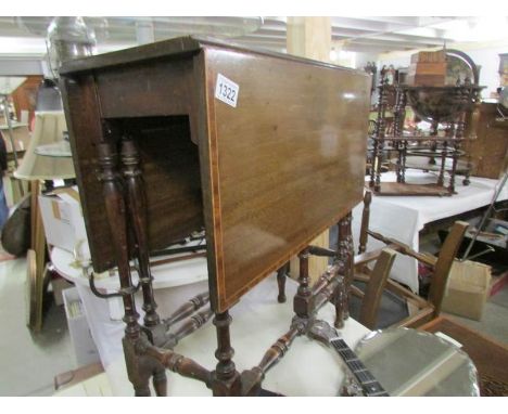 A mahogany inlaid gate leg table