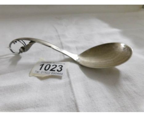 A sterling silver ornate ladle by George Jensen