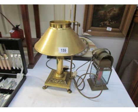 A brass table lamp and a lantern style candle lamp