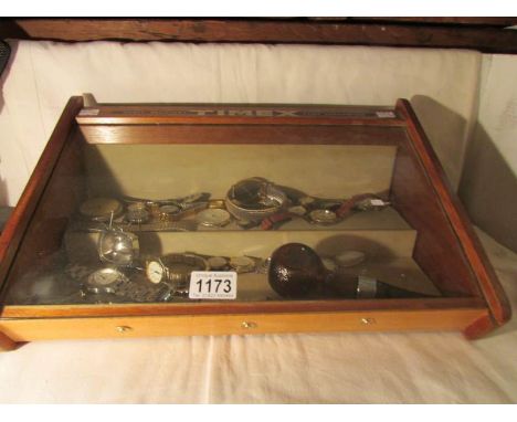 A Timex advertising cabinet with contents