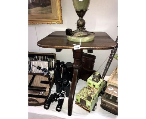 An oak tilt top tripod table