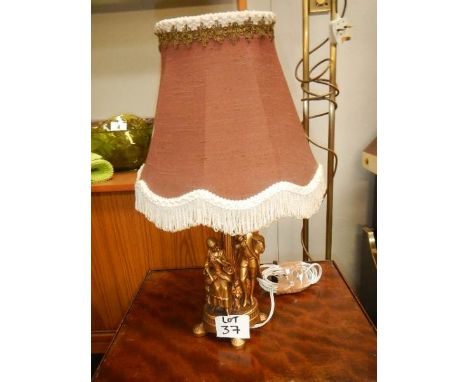 A figural table lamp with shade