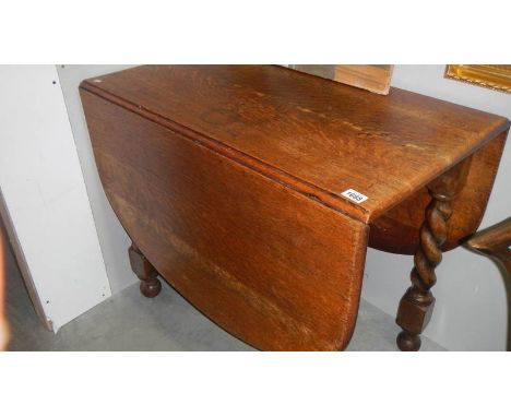 An oak barley twist gate leg table