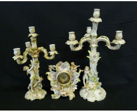 A Late 19th Early 20th Century Berlin Porcelain Three Branch Candelabrum with Putti Cresting, together with another similar c