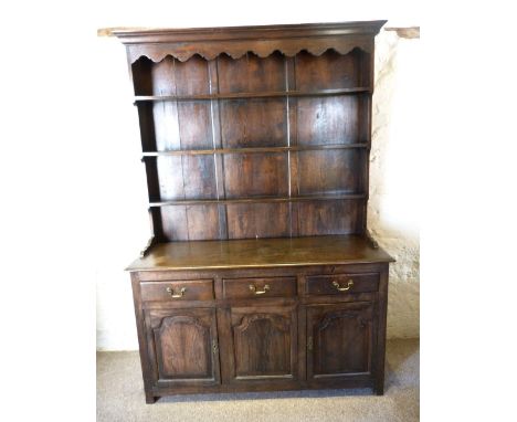 A Late 19th Early 20th Century Oak Dresser, the boarded shelf back above three drawers and three panelled doors flanked by st