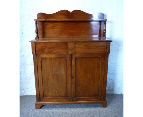 A 19th Century Mahogany Chiffonier, with a shaped shelf back above two frieze drawers and two cupboards doors enclosing shelv