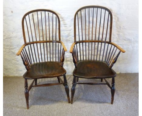 A Late 18th or Early 19th Century Yew and Elm Windsor Armchair, with a stick back above a panelled seat raised upon turned le