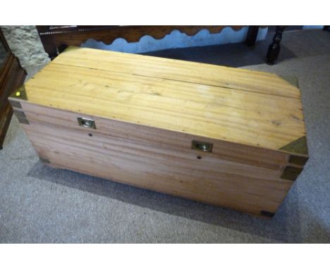 An Early 19th Century Camphor Campaign Trunk with brass corner mounts and sunken brass handles, 122 cms wide
