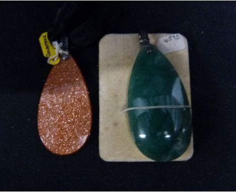 A Gold Stone Oval Pendant, together with another similar green jade oval pendant