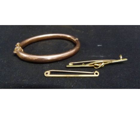 A 9ct. Gold Bangle, 11.1 gms, together with an 18ct. gold tie clip, 2.4 gms and a 15ct. gold bar brooch, 4 gms