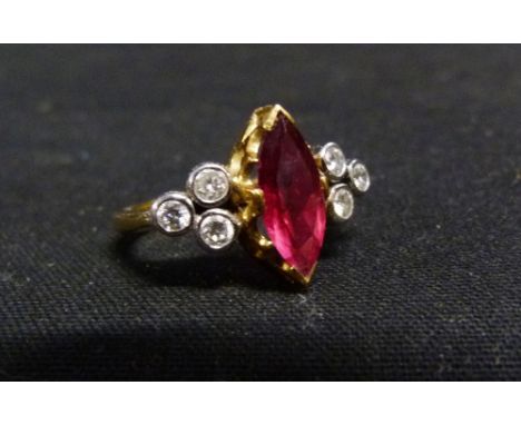 An 18ct. Gold Ruby and Diamond Ring, with a central marquise ruby flanked by six diamonds in a pierced setting