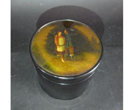 A Russian Papier Mache Cylindrical Tea Caddy, the cover hand painted with figures within a landscape, 12 cms diameter