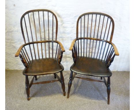 A Late 18th or Early 19th Century Yew and Elm Windsor Armchair, with a stick back above a panelled seat raised upon turned le