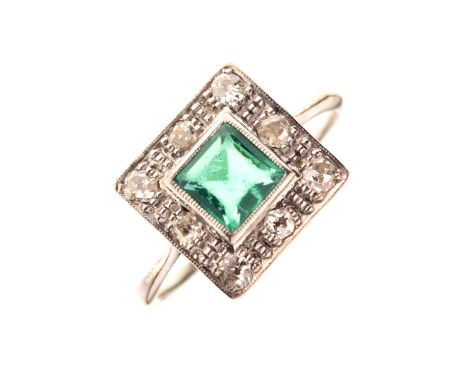 Emerald and diamond cluster ring, the square cut emerald surround by a border of old cut diamonds, indistinctly stamped, size