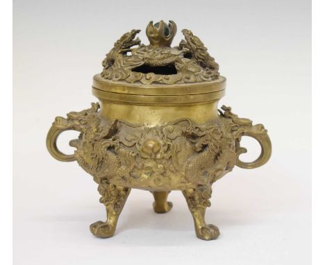 Japanese cast bronze koro, the pierced domed cover with captive ball finial, the two-handled body modelled in high relief wit