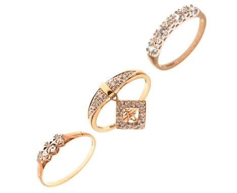 Three 9ct gold diamond set dress rings comprising an illusion set three stone diamond ring, a half eternity ring set pale blu