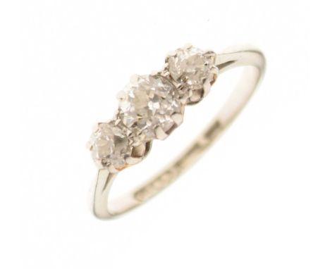 Three stone diamond ring, the graduated old cuts set in a white metal mount stamped '18ct' and 'PT', size L approx, 2.4g gros