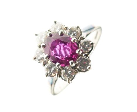 Ruby and diamond 18ct white gold cluster ring, the oval cut measuring approximately 6mm x 5.2mm x 3.1mm deep, enclosed by eig